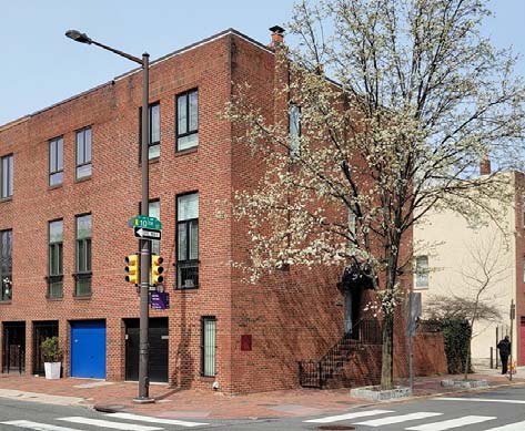 1001 Lombard Street at the corner of 10th, a 1978 brick rowhouse with a blue garage door